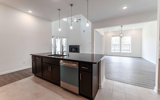 8406 Crab Blossom Dr, Cypress, TX 77433 - kitchen with a sink, open floor plan, a ceiling fan, stainless steel dishwasher, and dark countertops