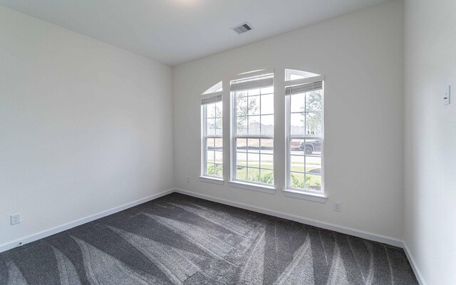 8406 Crab Blossom Dr, Cypress, TX 77433 - spare room featuring baseboards, dark carpet, and visible vents