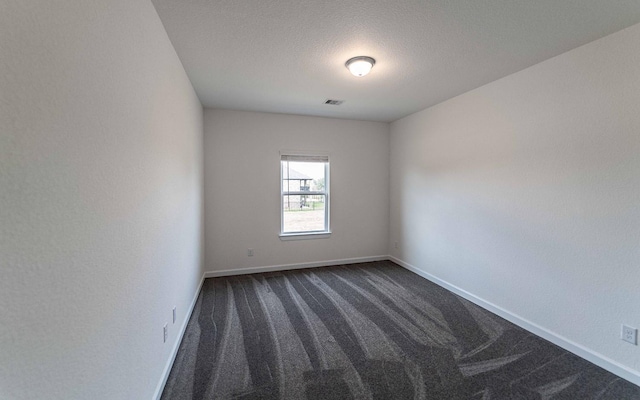 8406 Crab Blossom Dr, Cypress, TX 77433 - unfurnished room featuring a textured ceiling, baseboards, visible vents, and dark carpet