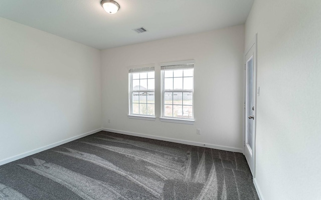 8406 Crab Blossom Dr, Cypress, TX 77433 - empty room featuring baseboards, dark colored carpet, and visible vents