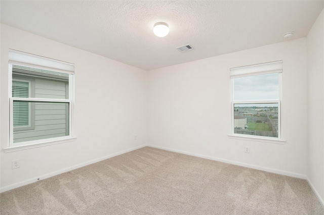 14627 Monterey Cypress Dr, Houston, TX 77068 - unfurnished room with a textured ceiling, carpet floors, baseboards, and visible vents