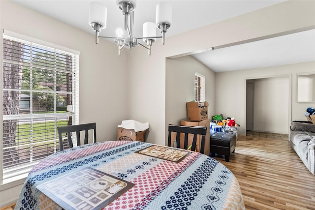 bedroom with a notable chandelier and wood finished floors