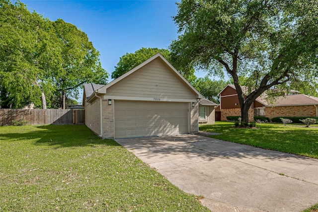 view of front of home with a front yard, brick siding, an attached garage, and fence