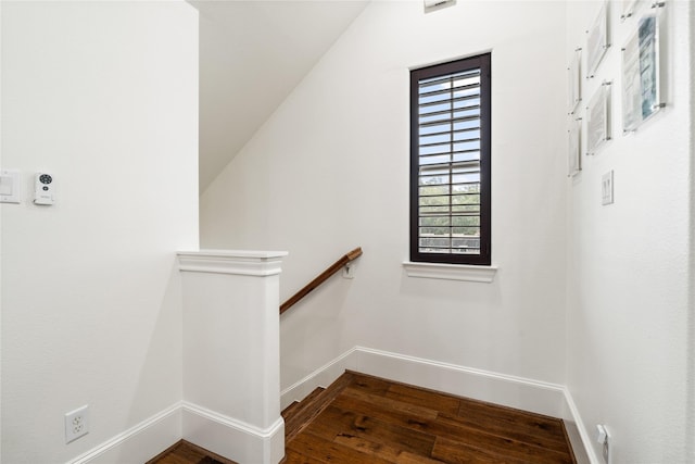 stairway featuring baseboards and wood finished floors