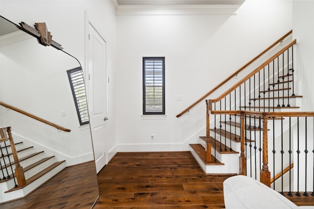 entryway featuring baseboards, stairway, crown molding, and wood finished floors