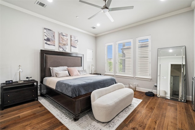bedroom with crown molding, visible vents, and wood finished floors
