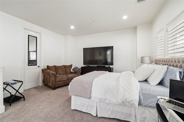 bedroom featuring light carpet, visible vents, and recessed lighting