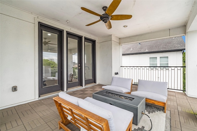 view of patio featuring an outdoor living space with a fire pit and a ceiling fan