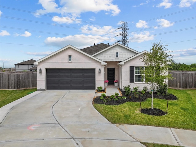 ranch-style house featuring a front lawn, driveway, a garage, and fence