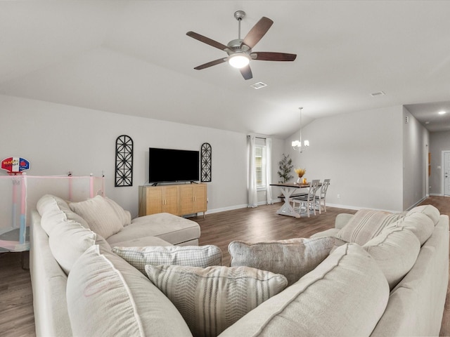 living room with lofted ceiling, baseboards, visible vents, ceiling fan with notable chandelier, and wood finished floors