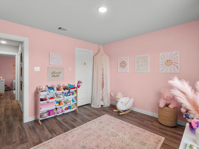 playroom featuring baseboards, visible vents, and wood finished floors
