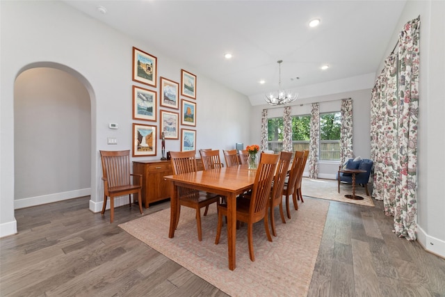 145 Lily Green Ct, Conroe, TX 77304 - dining room with wood finished floors, a chandelier, arched walkways, recessed lighting, and baseboards