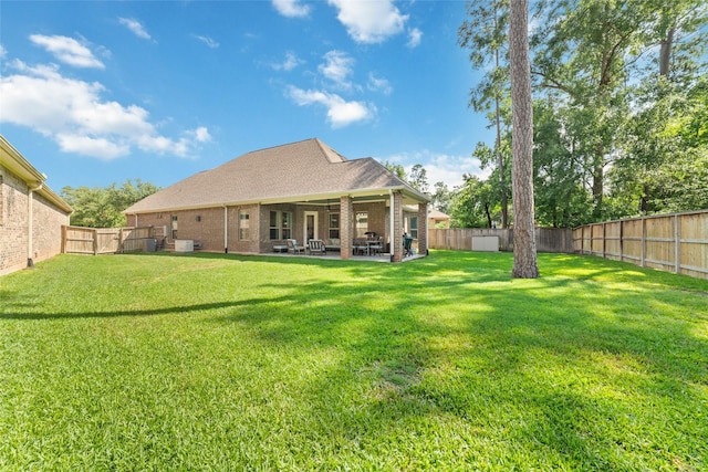 145 Lily Green Ct, Conroe, TX 77304 - back of property with brick siding and a patio