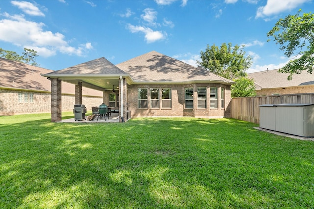 145 Lily Green Ct, Conroe, TX 77304 - rear view of property featuring brick siding, a patio, and a shingled roof