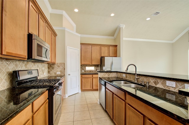 8523 Dolan Heights Ct, Cypress, TX 77433 - kitchen with light tile patterned floors, ornamental molding, a sink, dark stone countertops, and appliances with stainless steel finishes