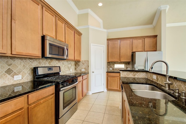 8523 Dolan Heights Ct, Cypress, TX 77433 - kitchen with light tile patterned floors, stainless steel appliances, crown molding, and a sink