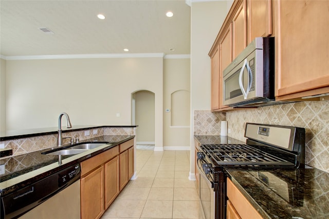 8523 Dolan Heights Ct, Cypress, TX 77433 - kitchen featuring a sink, stainless steel appliances, visible vents, arched walkways, and ornamental molding