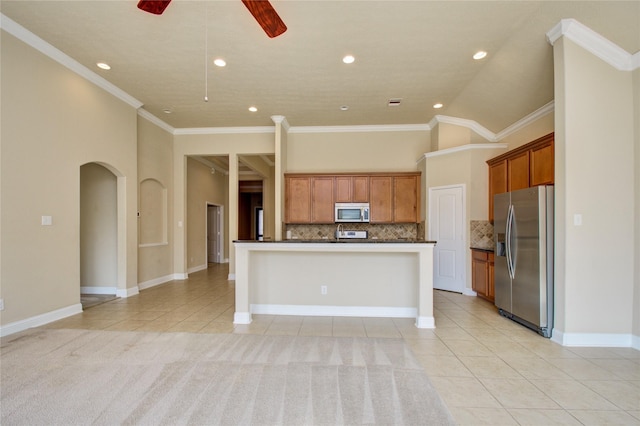 8523 Dolan Heights Ct, Cypress, TX 77433 - kitchen featuring light tile patterned floors, ceiling fan, dark countertops, tasteful backsplash, and appliances with stainless steel finishes