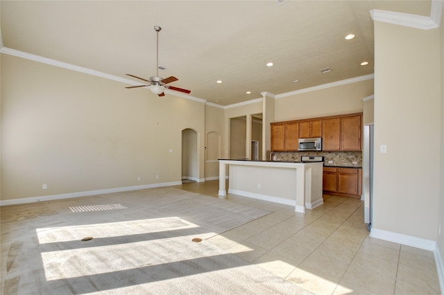 8523 Dolan Heights Ct, Cypress, TX 77433 - kitchen with brown cabinets, dark countertops, stainless steel appliances, arched walkways, and recessed lighting