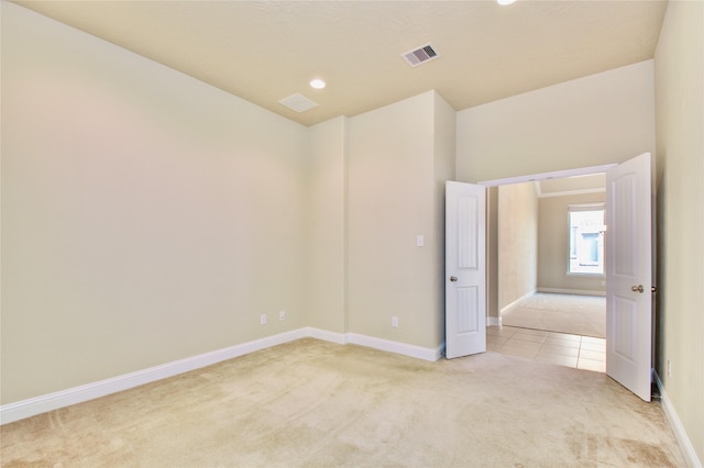 8523 Dolan Heights Ct, Cypress, TX 77433 - unfurnished room featuring light colored carpet, visible vents, recessed lighting, light tile patterned floors, and baseboards