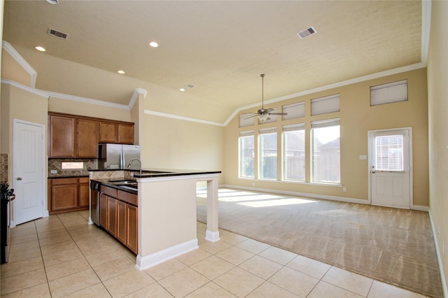8523 Dolan Heights Ct, Cypress, TX 77433 - kitchen featuring light tile patterned floors, light carpet, stainless steel appliances, and crown molding