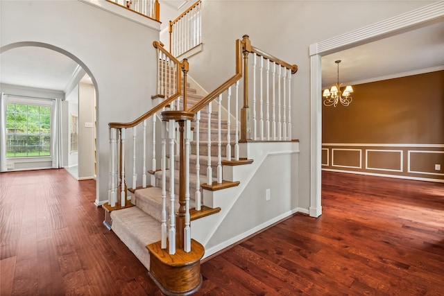 6615 Cypress Village Dr, Sugar Land, TX 77479 - stairs with wood finished floors, crown molding, wainscoting, arched walkways, and a chandelier