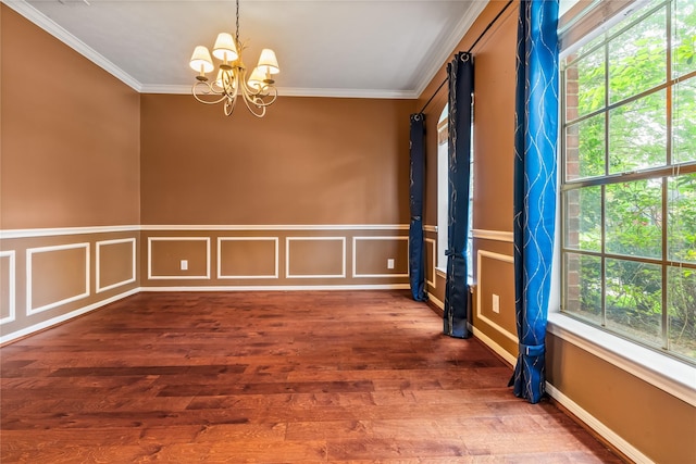 6615 Cypress Village Dr, Sugar Land, TX 77479 - empty room with an inviting chandelier, crown molding, a wainscoted wall, and wood finished floors