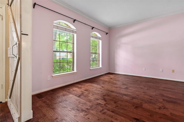 6615 Cypress Village Dr, Sugar Land, TX 77479 - spare room with baseboards, a barn door, crown molding, and wood finished floors