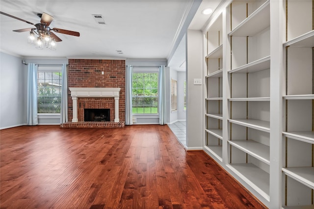 6615 Cypress Village Dr, Sugar Land, TX 77479 - unfurnished living room featuring baseboards, ornamental molding, ceiling fan, a brick fireplace, and wood finished floors