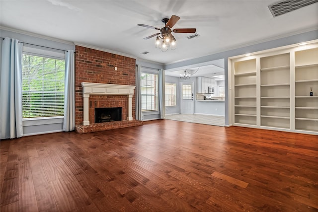 6615 Cypress Village Dr, Sugar Land, TX 77479 - unfurnished living room with ornamental molding, ceiling fan with notable chandelier, visible vents, and wood finished floors