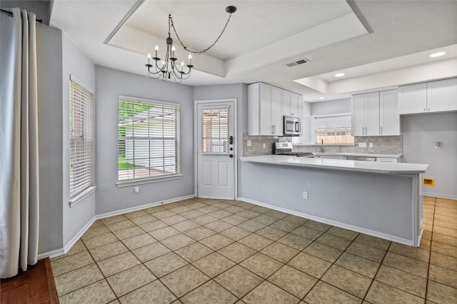 6615 Cypress Village Dr, Sugar Land, TX 77479 - kitchen featuring a chandelier, stainless steel appliances, visible vents, and a raised ceiling