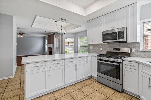 6615 Cypress Village Dr, Sugar Land, TX 77479 - kitchen with a peninsula, light countertops, stainless steel appliances, and backsplash