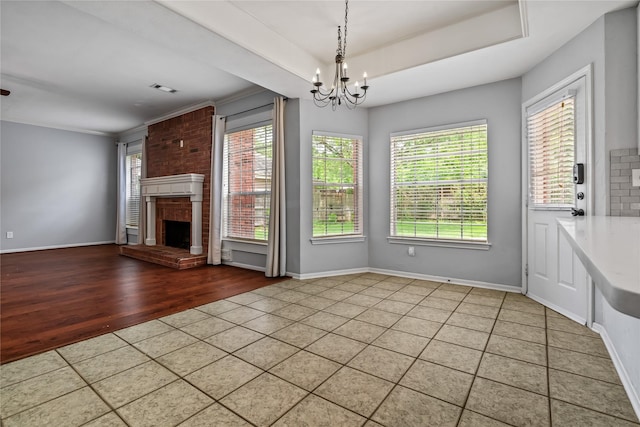 6615 Cypress Village Dr, Sugar Land, TX 77479 - interior space with wood finished floors, a brick fireplace, visible vents, baseboards, and a chandelier