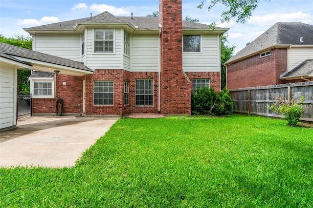 6615 Cypress Village Dr, Sugar Land, TX 77479 - rear view of house featuring a chimney, a yard, brick siding, fence, and a patio area