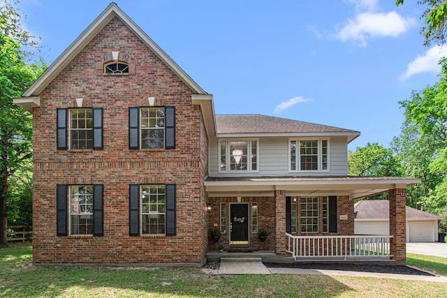 6811 S Trace Dr, Magnolia, TX 77354 - traditional-style house with a front yard, a porch, and brick siding