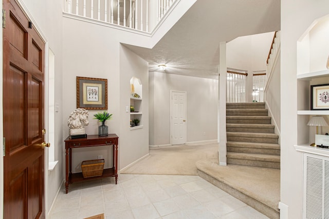 6811 S Trace Dr, Magnolia, TX 77354 - foyer entrance featuring light colored carpet, stairs, and baseboards