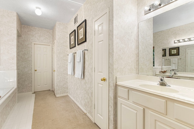 6811 S Trace Dr, Magnolia, TX 77354 - full bathroom featuring wallpapered walls, tiled bath, visible vents, and vanity