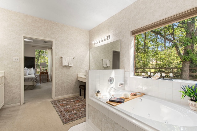 6811 S Trace Dr, Magnolia, TX 77354 - full bath with a tub with jets, wallpapered walls, ensuite bathroom, baseboards, and vanity