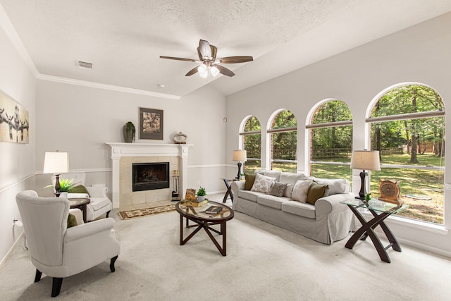 6811 S Trace Dr, Magnolia, TX 77354 - living room featuring a ceiling fan, a textured ceiling, carpet flooring, visible vents, and a fireplace
