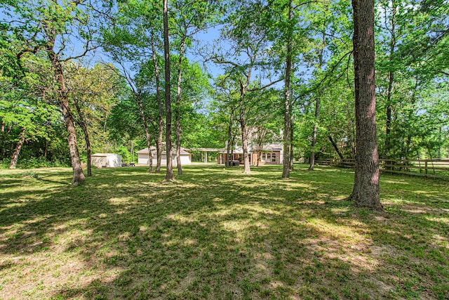 6811 S Trace Dr, Magnolia, TX 77354 - view of yard featuring an outbuilding and fence