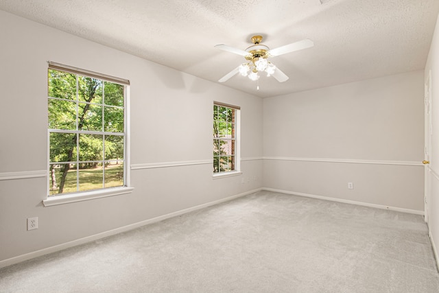6811 S Trace Dr, Magnolia, TX 77354 - spare room with a ceiling fan, light carpet, a healthy amount of sunlight, and baseboards