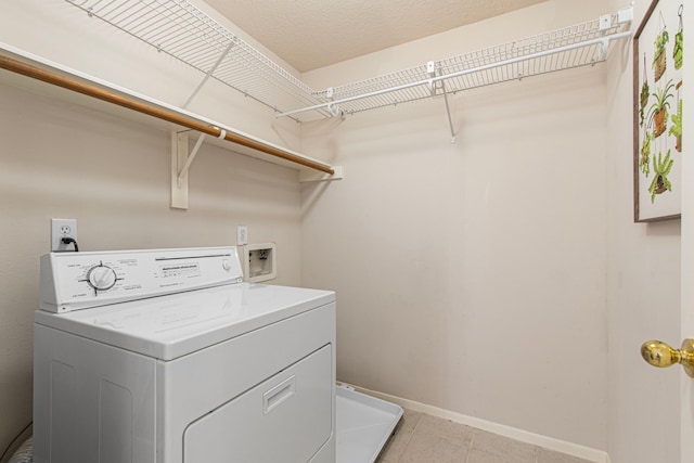 6811 S Trace Dr, Magnolia, TX 77354 - laundry room featuring laundry area, baseboards, light tile patterned floors, and washer / dryer