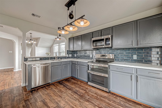 1339 Kane Ct, Rosenberg, TX 77471 - kitchen featuring gray cabinetry, visible vents, a sink, tasteful backsplash, and appliances with stainless steel finishes