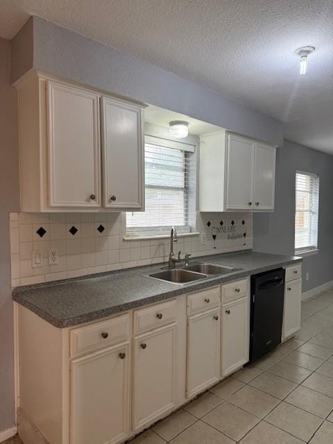 1101 E Brown Ln, Deer Park, TX 77536 - kitchen featuring dishwasher, a sink, baseboards, backsplash, and a textured ceiling
