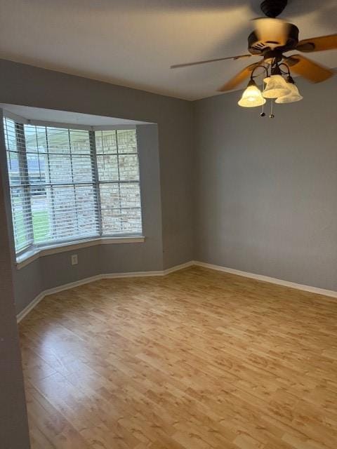 1101 E Brown Ln, Deer Park, TX 77536 - unfurnished room featuring light wood-style floors, baseboards, and ceiling fan