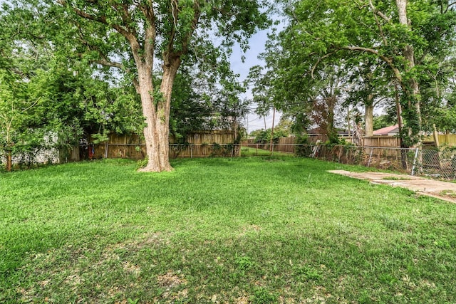 view of yard with a fenced backyard