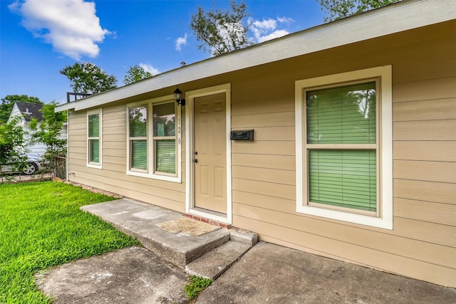 property entrance with a yard