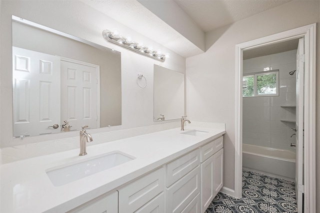 bathroom featuring a sink, tile patterned flooring, double vanity, and shower / bath combination