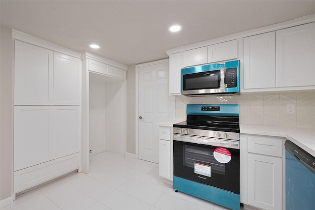 kitchen featuring tasteful backsplash, light tile patterned floors, light countertops, white cabinets, and appliances with stainless steel finishes