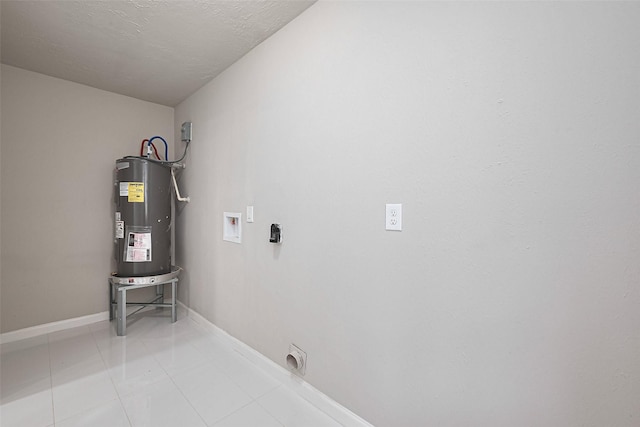 washroom featuring laundry area, water heater, light tile patterned floors, electric dryer hookup, and washer hookup